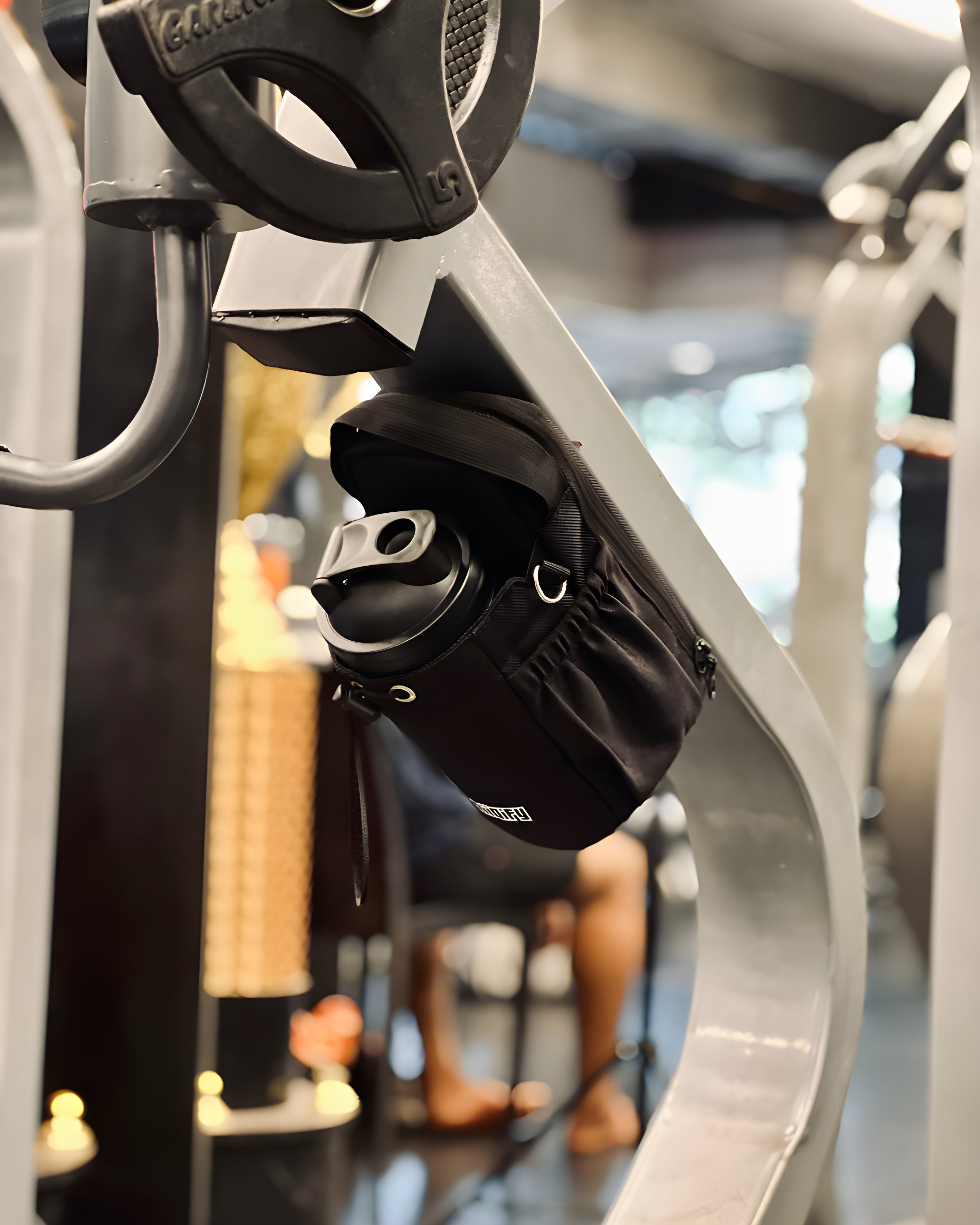 Hiipack magnetic gym organizer securely attached to gym equipment, holding a water bottle and essentials for hands-free workout convenience